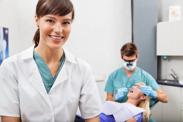 Dental assistant in an exam room