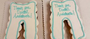 Two cakes in the shape of teeth, decorated as teeth with "Thank You Dental Assistants" written on it. Looking for a Dental Assisting Program in Crystal Lake or Libertyville? Call First Institute today!