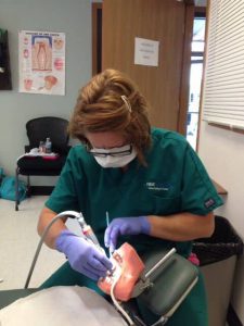 A Dental Assistant student practises a cleaning procedure on a mannequin. Check out First Institute, which offers a Dental Assisting Program in Libertyville and Crystal Lake, IL